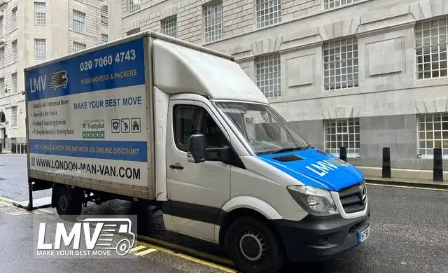 Movers loading van with furniture and boxes for affordable local delivery services in South West London