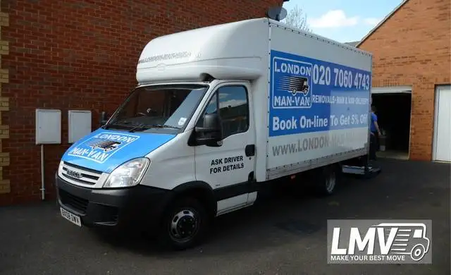 Moving team in Cobham packing and loading boxes into the van for a London move
