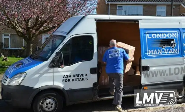 Movers in Cobham loading van with boxes