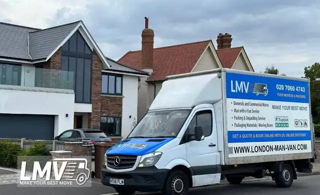 Professional movers in East Central London carrying boxes and loading a van for house move