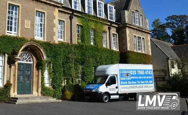Man Van Queens Park team loading boxes into a van with driver for local move
